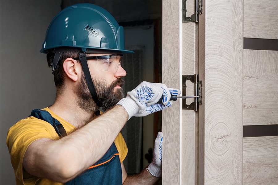 A constructor working on a door frame